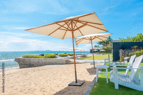 lounge chairs with sun umbrella on a beach © tonefotografia
