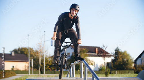 Fototapeta Naklejka Na Ścianę i Meble -  Guy on a road stunt bicycle smiling