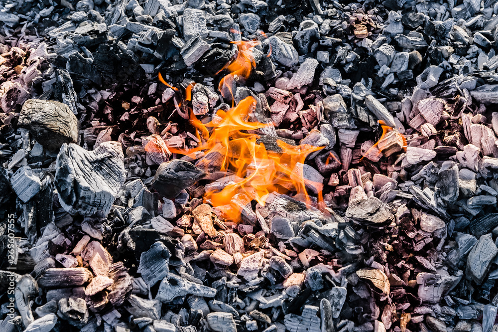 small fire on the texture of coal flat lay