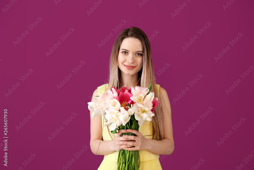 Young woman with bouquet of beautiful tulips on color background