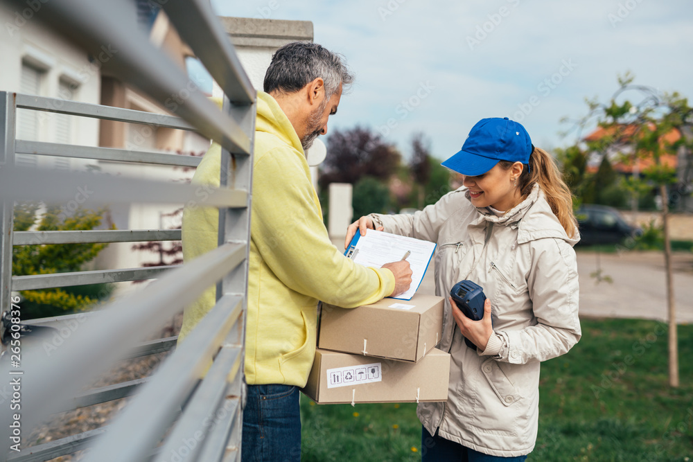 man signing for package delivery man signing for package delivery