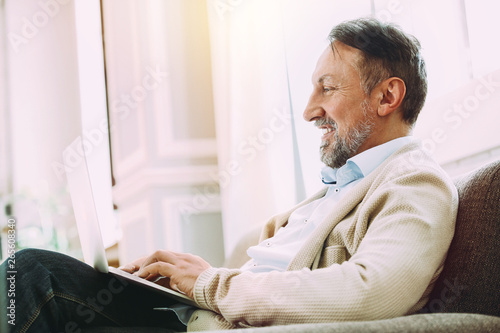 Handsome mature man using l...