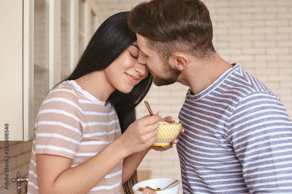 Cute young couple having breakfast in kitchen Cute young couple having breakfast in kitchen
