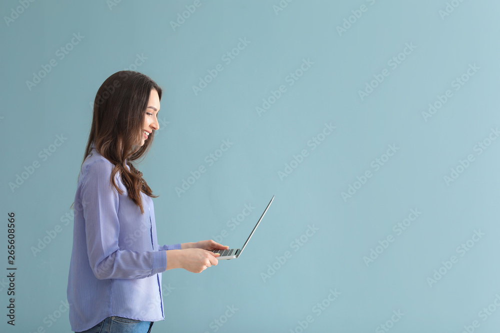 Beautiful young woman with laptop on grey background Beautiful young woman with laptop on grey background