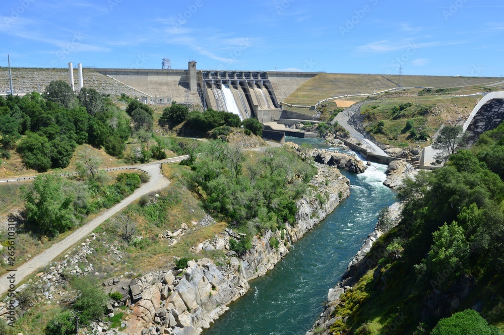 Folsom Dam in California with a sluice gaten open..