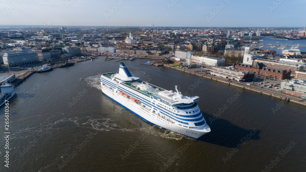 Finland, Helsinki. Summer evening. The ship, white cruise passenger liner, leaves the city port. Panorama of the capital, view on embankment and the cathedral. 