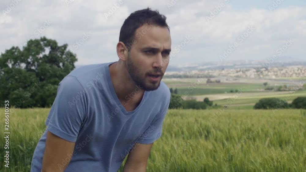 Exhausted runner stops to take a breath and then runs. Set in rural area Exhausted runner stops to take a breath and then runs. Set in rural area