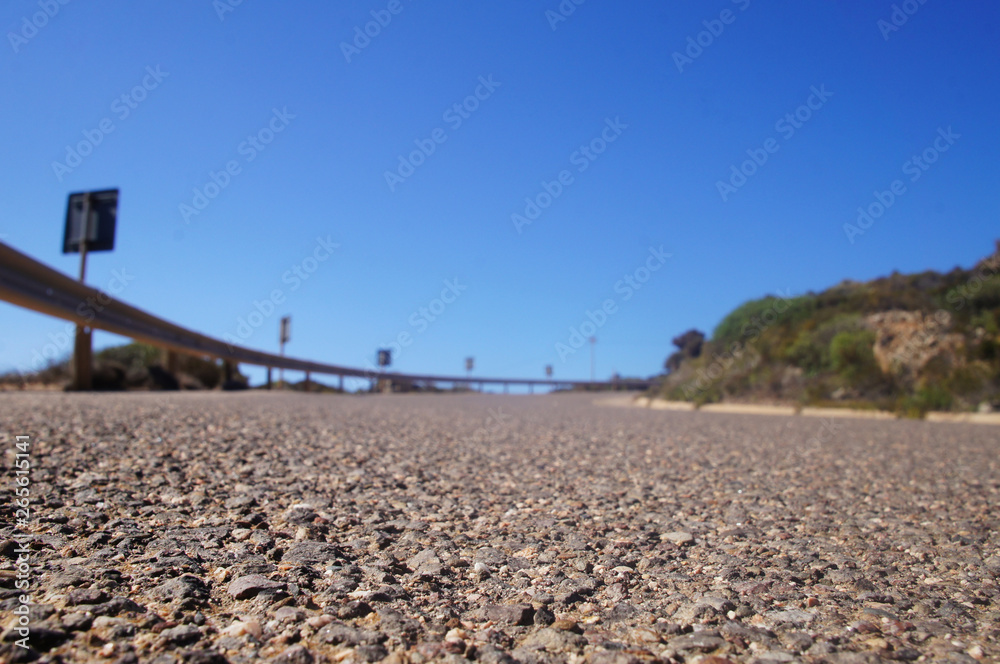Empty clean smooth highway road close up on a sunny summer tropical island near the mountains and the sea for background.