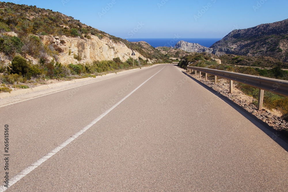 Empty clean smooth highway road close up on a sunny summer tropical island near the mountains and the sea for background. Empty clean smooth highway road close up on a sunny summer tropical island near the mountains and the sea for background.