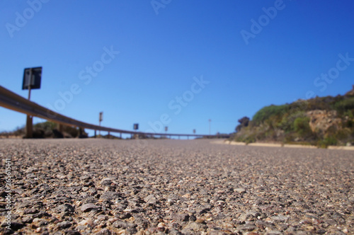 Empty clean smooth highway road close up on a sunny summer tropical island near the mountains and the sea for background.