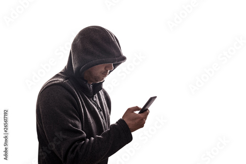Hooded hacker holding smartphone isolated on white background