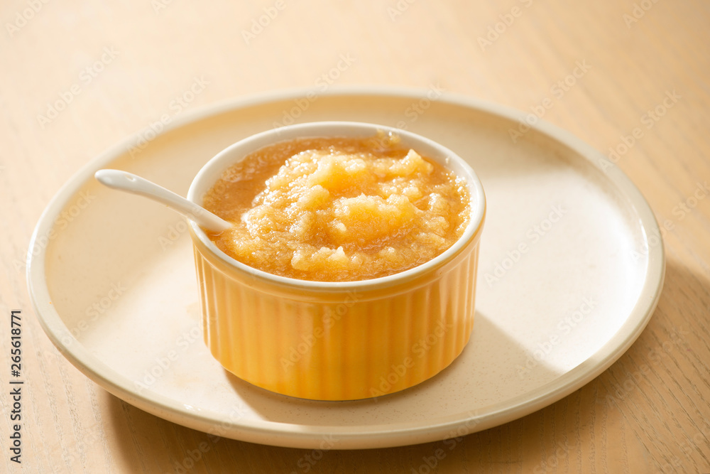 Natural baby food concept. Bowl of apple baby puree.