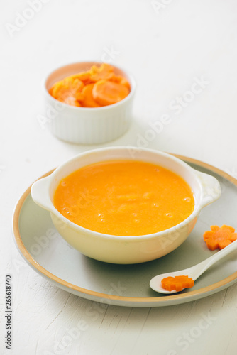 Carrot baby puree in bowl isolated on light background