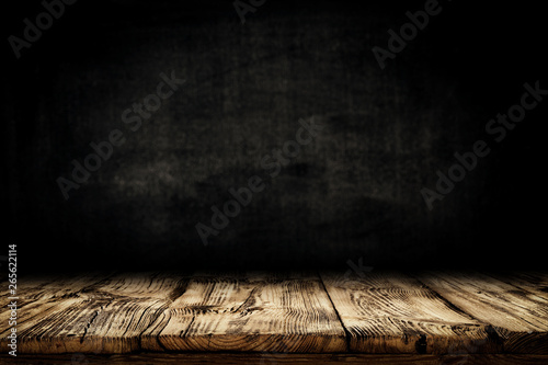 Dark desk background of free space for your decoration and black wall space 