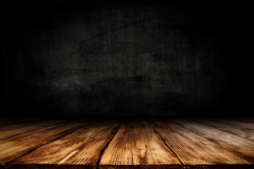 Dark desk background of free space for your decoration and black wall space 