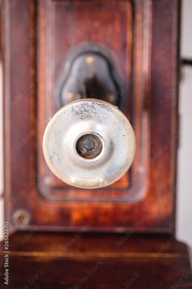 Fototapeta premium Retro phone on a white wall, antique isolated on white background.