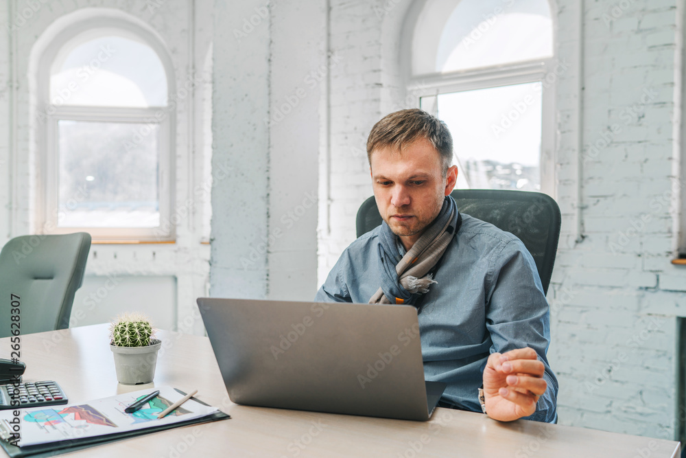 Young businessman using his laptop at the modern office Young businessman using his laptop at the modern office