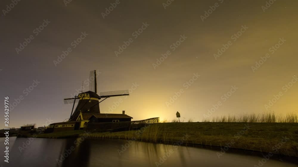 Landscape at night and a old Dutch traditional windmill located at Rottemeren lake near Rotterdam. Landscape at night and a old Dutch traditional windmill located at Rottemeren lake near Rotterdam.