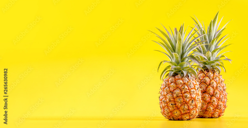 Beautiful fresh pineapple isolated on bright yellow background, summer seasonal fruit design idea pattern concept, copy space, close up