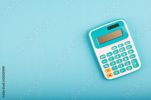 close-up and selective focus shot, calculator on blue background. copy space for text