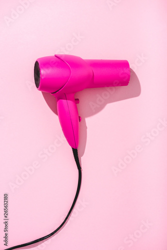 top view of hair dryer on pink with copy space