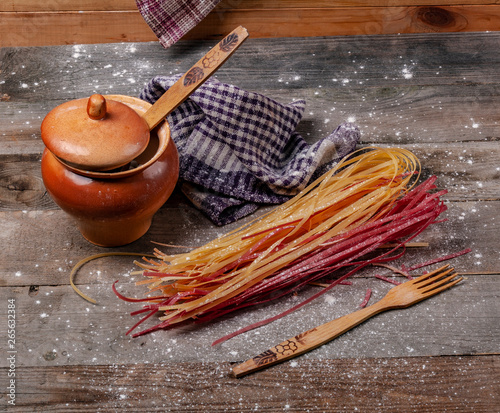 A lot of spaghetti on a wooden table. photo