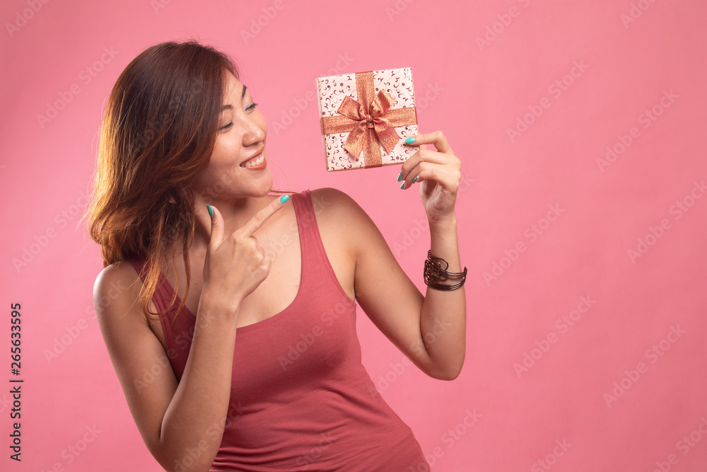 Young Asian woman with a gift box. Young Asian woman with a gift box.