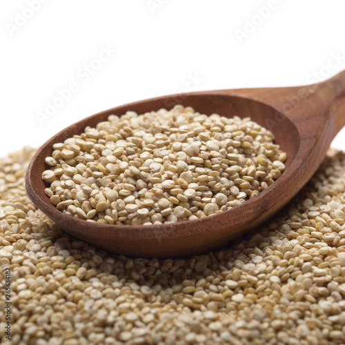 Raw organic superfood gluten free quinoa seeds in wooden spoon closeup on white background
