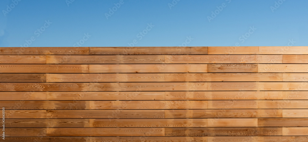 Wooden boundary fence around a property Wooden boundary fence around a property