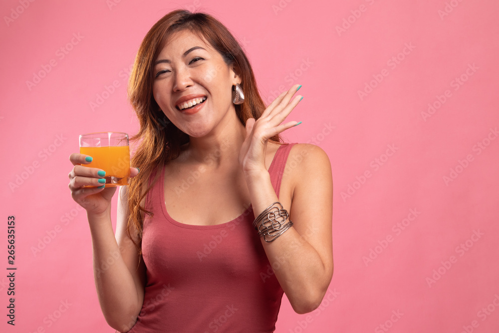 Happy Young Asian woman drink orange juice. Happy Young Asian woman drink orange juice.