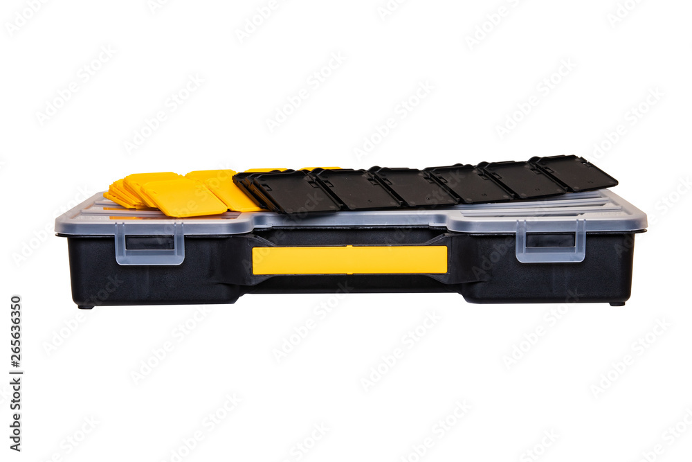 Equipment of craftsman. A empty professional black plastic storage and a lot of black and yellow partitions for setting up compartments isolated on a white background. Handyman accessories.