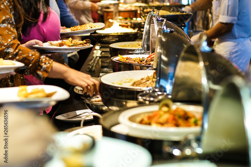 Hand of people take buffet food in hotel party photo