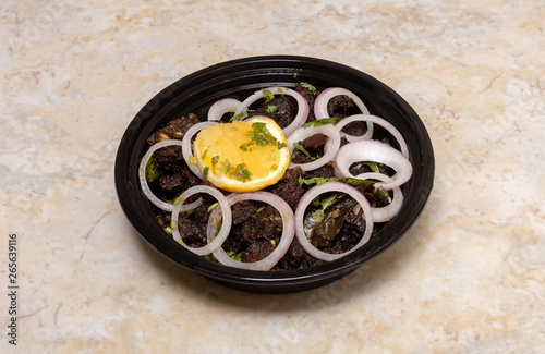 Slow Roasted Beef. Kerala style spicy beef dry fry served with raw onion and lemon in plastic disposable plate for delivery. South Indian famous dish. Top view. photo