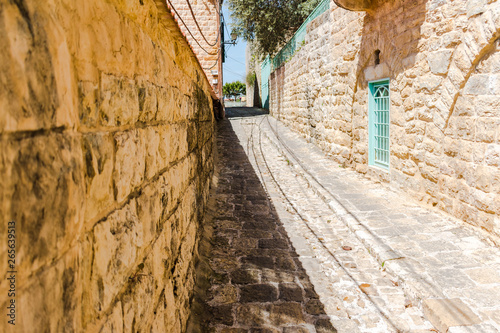 This is a capture of the old roads in Der El Kamar a village Located in Lebanon and you can see in the picture the old walk made of stones with an historic architecture for walls and houses 