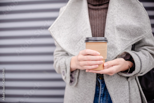 Woman female hand with coffee cup paper latte.