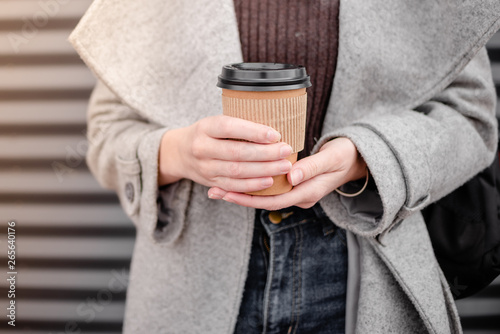 Woman female hand with coffee cup paper latte.