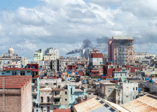 View over the rooftops of Havana, Cuba with oil refinery in distance