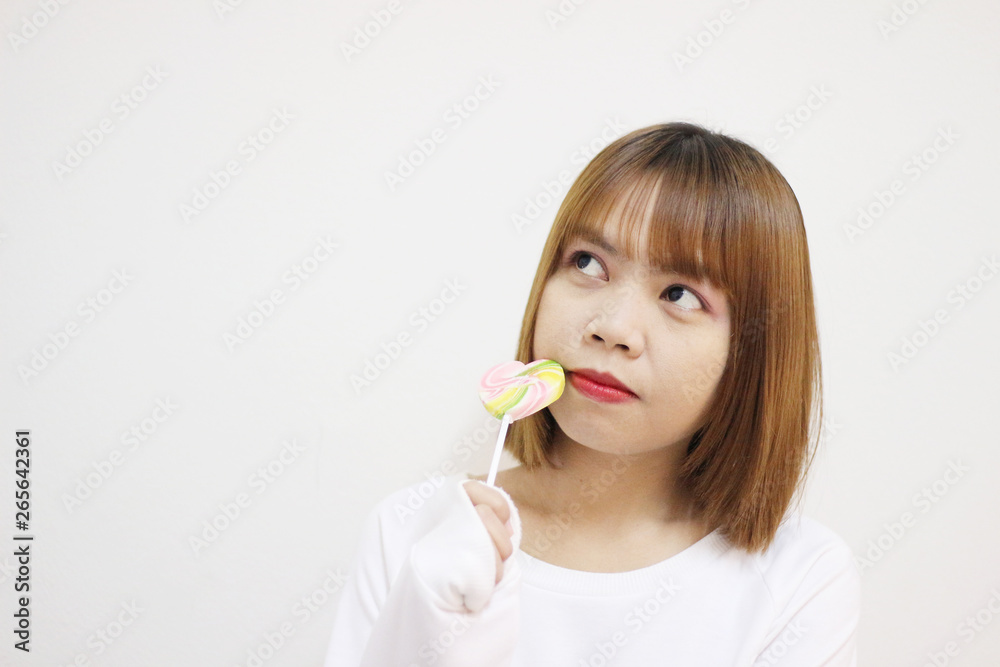 easterner girl eating colourful lollipop. easterner girl eating colourful lollipop.