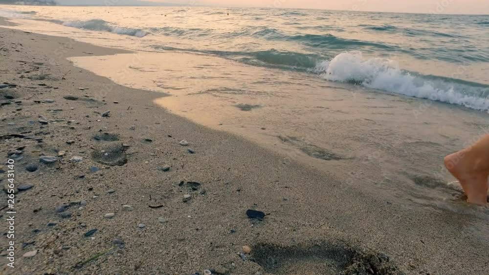 Fit attractive woman running on the beach barefoot, exercising in the morning at sunrise Fit attractive woman running on the beach barefoot, exercising in the morning at sunrise