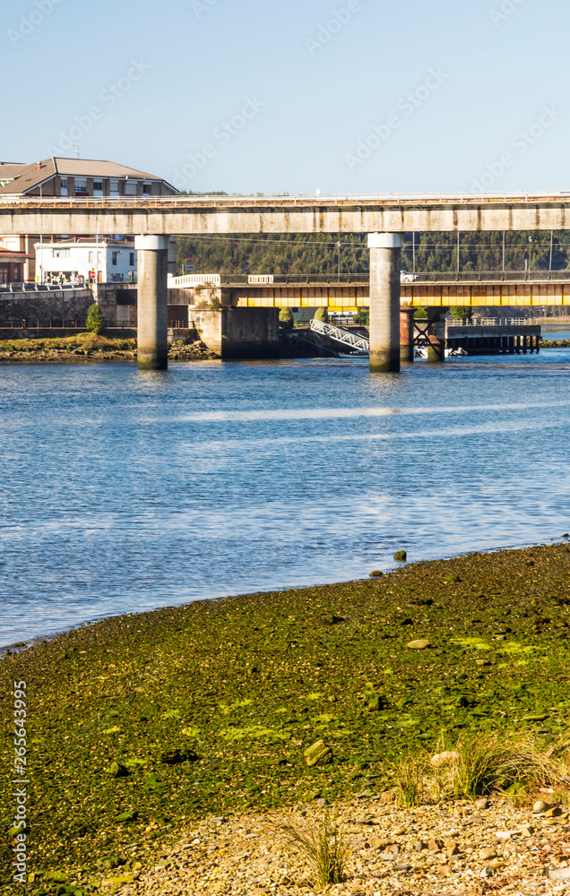 Naklejka premium Bridge in the ocean in a sunny day in the north of Spain.