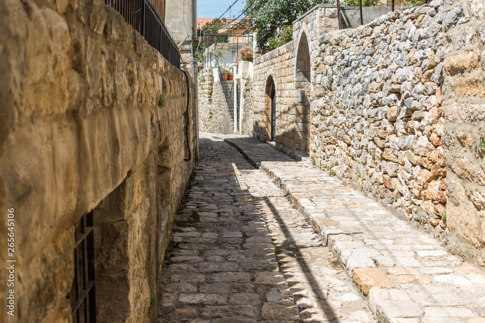 This is a capture of the old roads in Der El Kamar a village Located in Lebanon and you can see in the picture the old walk made of stones with an historic architecture for walls and houses This is a capture of the old roads in Der El Kamar a village Located in Lebanon and you can see in the picture the old walk made of stones with an historic architecture for walls and houses