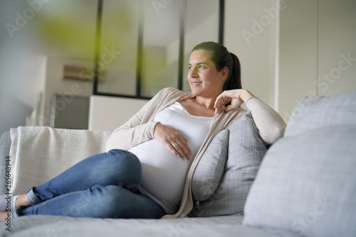 Portrait of pregnant woman relaxing in sofa