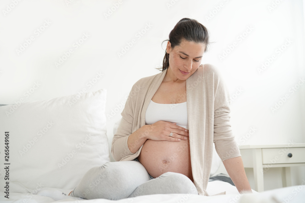 Portrait of pregnant woman relaxing on bed Portrait of pregnant woman relaxing on bed