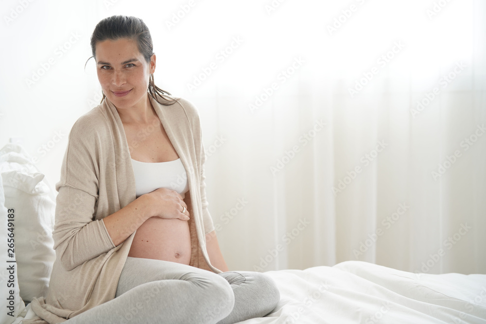 Portrait of pregnant woman relaxing on bed Portrait of pregnant woman relaxing on bed