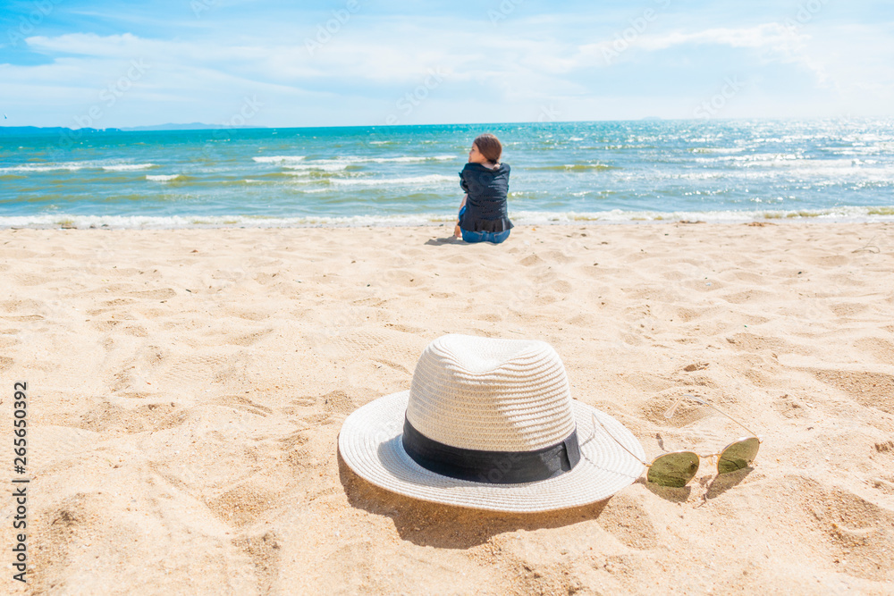 Beautiful woman is sitting on beach Beautiful woman is sitting on beach