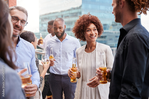 Office colleagues socialising with drinks in the city after work