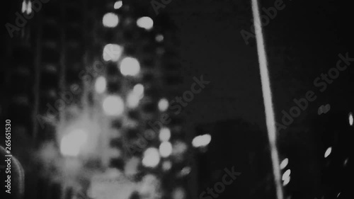 Blurred urban night life motion background loop. Ghetto street lights -  defocused dynamic hyper lapse. Big dirty city location.
