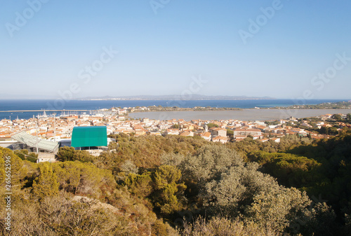 Top view of the old European city with red roofs near the sea in the summer on the southern island.