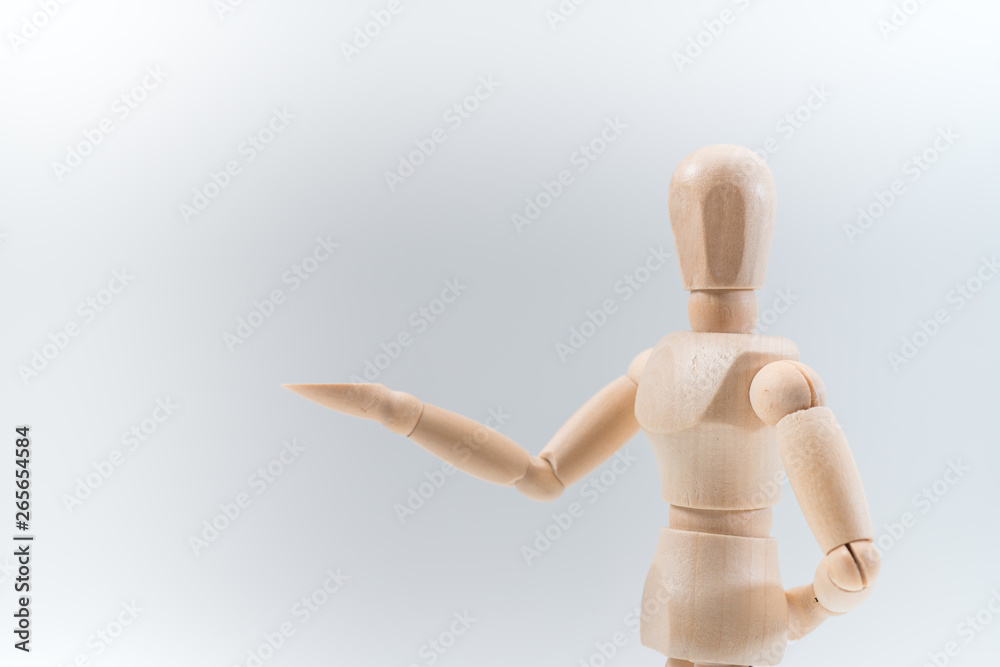 Wooden dummy proudly presents some invisible thing, isolated on white background, copy space for your object or text Wooden dummy proudly presents some invisible thing, isolated on white background, copy space for your object or text