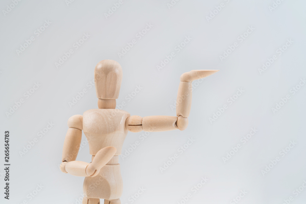 Wooden dummy proudly presents some invisible thing, isolated on white background, copy space for your object or text Wooden dummy proudly presents some invisible thing, isolated on white background, copy space for your object or text